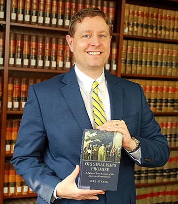 Dr Lee Strang with book